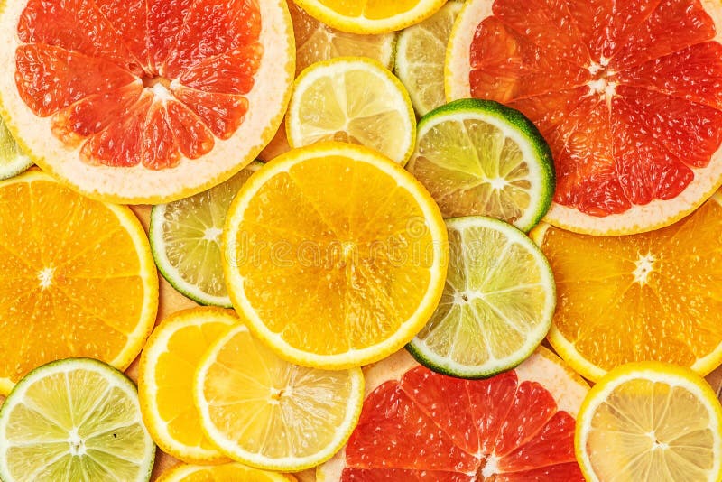 Mixed Fresh slices citrus fruit as background. Top view stock images