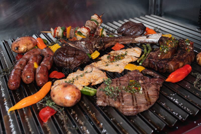 Mixed grill consisting of an assortment of grilled meats and vegetables on a barbecue grill