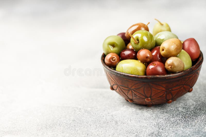 Mixed Marinated Olives Green and Purple in Ceramic Bowl Stock Image