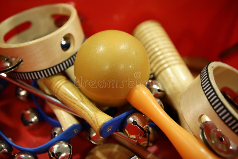 Mixed percussion toy instruments on red
