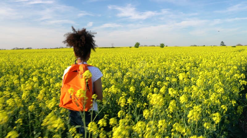 Mixed race African American girl teenager female young woman hiking with red backpack