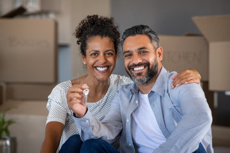 Mixed race couple holding new house keys