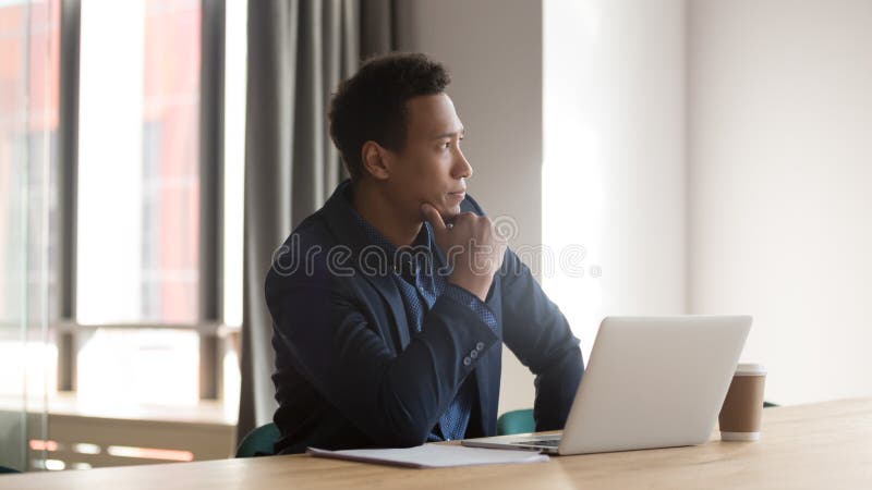 Mixed race entrepreneur sit at desk looking out the window