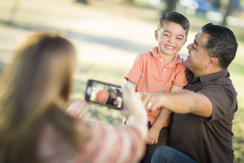 Mixed Race Family Taking Pictures with a Smart Phone Camera stock photo Mixed Race Family Taking Pictures with a Smart Phone Camera stock photo