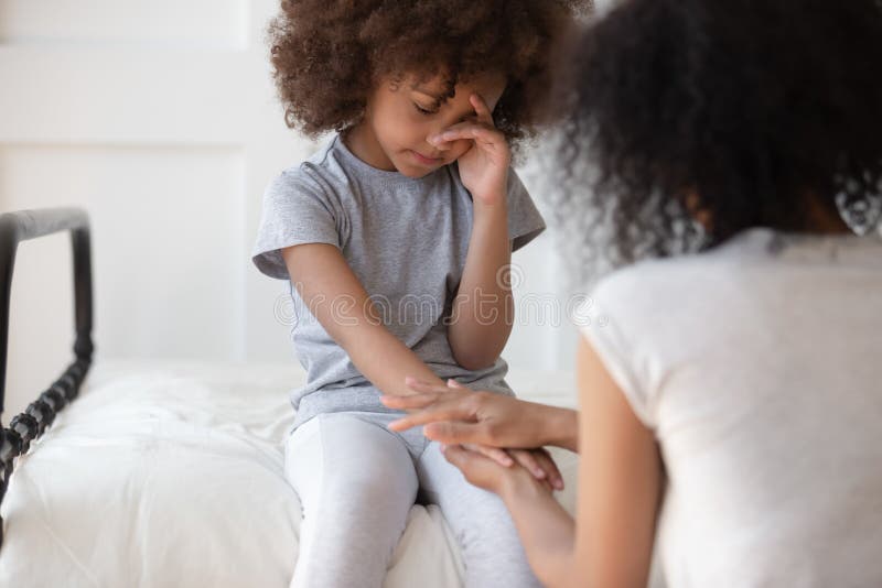 Mixed race mommy comforting upset little cute girl. royalty free stock photo Mixed race mommy comforting upset little cute girl. royalty free stock photo