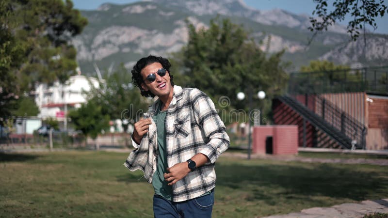 Mixed race overjoyed casual man dancing at summer sunny mountain park good mood positive emotion stock footage