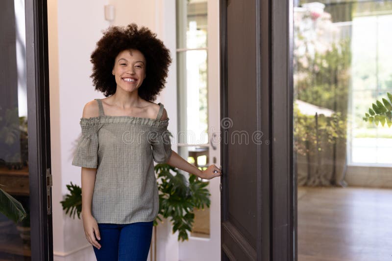 Mixed race woman holding a door handle