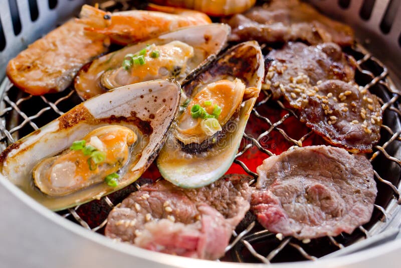Mixed Roasted Meat and Seafood on the BBQ Grill on Roast. Stock Photo
