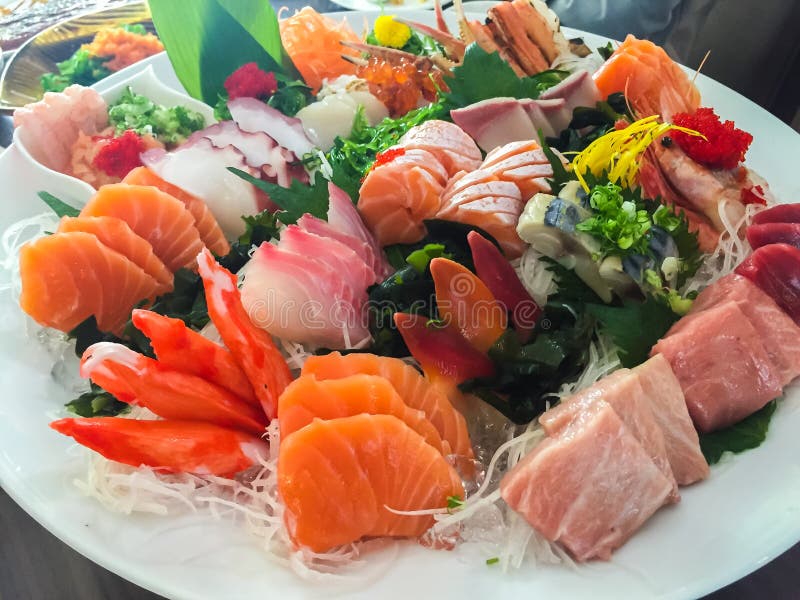 Mixed sushi served on a white plate.