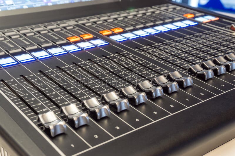 Hand push volume up. ,mixer music in studio. , professional sound engineer.