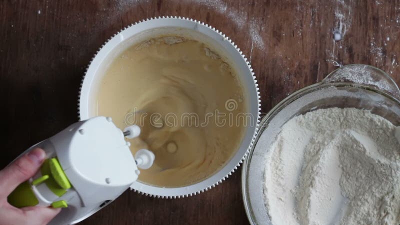 Mixing dough with electric mixer. Accelerated video