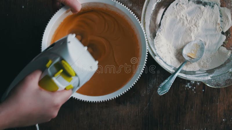 Mixing dough with electric mixer. Cooking at home.