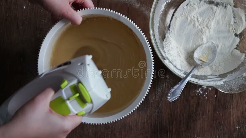 Mixing dough with electric mixer. Cooking at home.