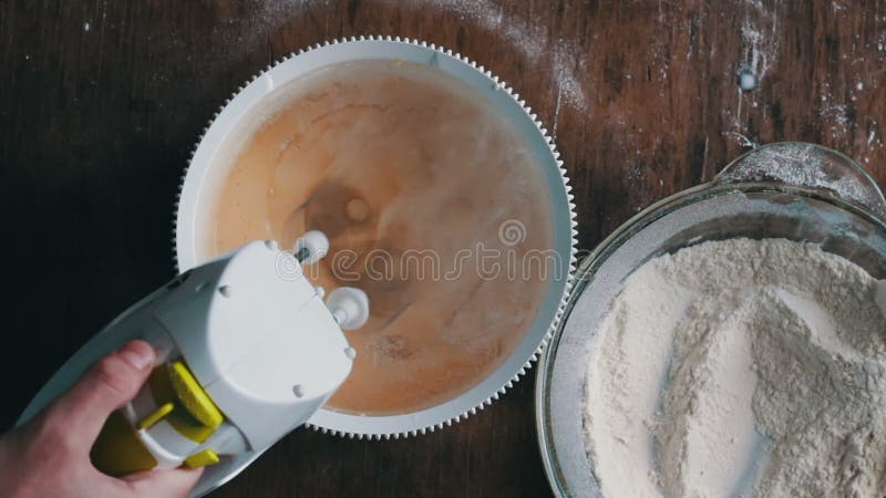 Mixing dough with electric mixer. Cooking at home.
