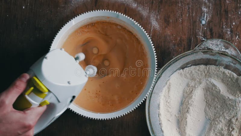 Mixing dough with electric mixer. Cooking at home.