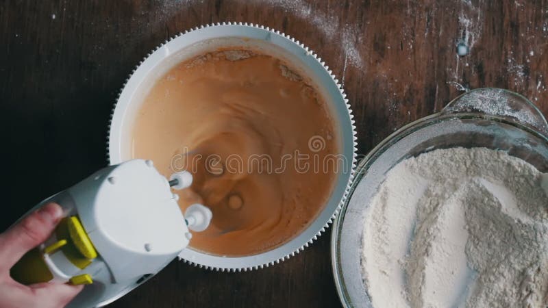 Mixing dough with electric mixer. Cooking at home.