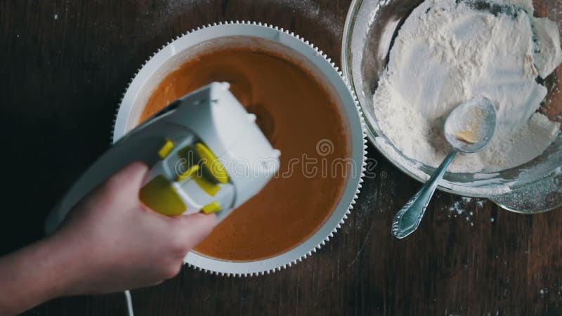 Mixing dough with electric mixer. Cooking at home.