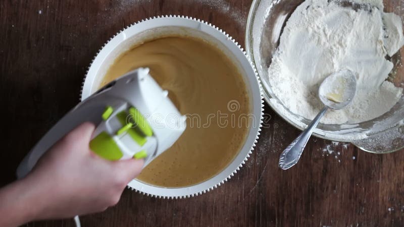 Mixing dough with electric mixer. Cooking at home.