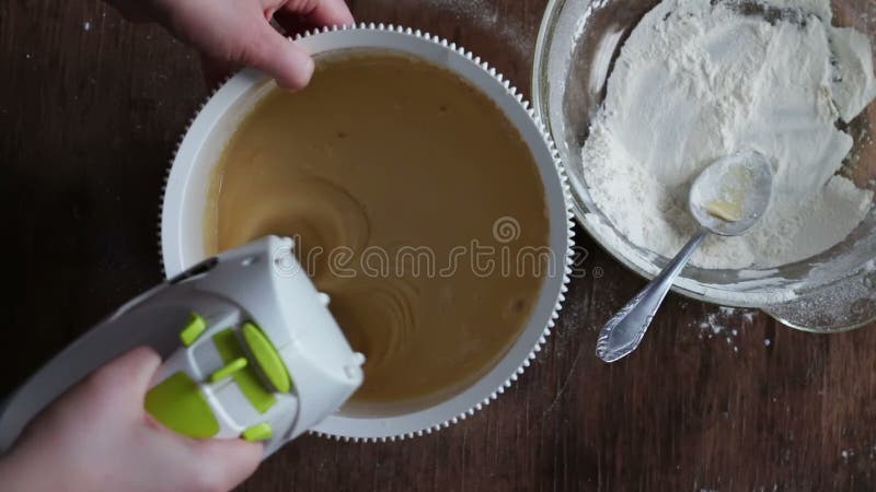 Mixing dough with electric mixer. Cooking at home.