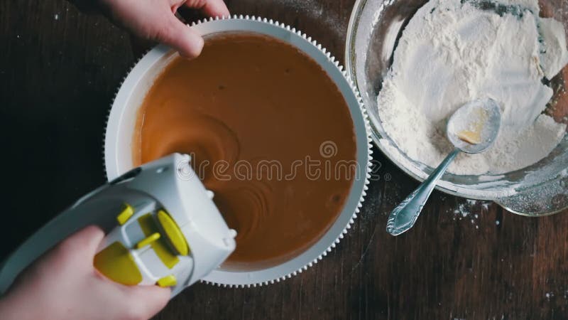 Mixing dough with electric mixer. Cooking at home.