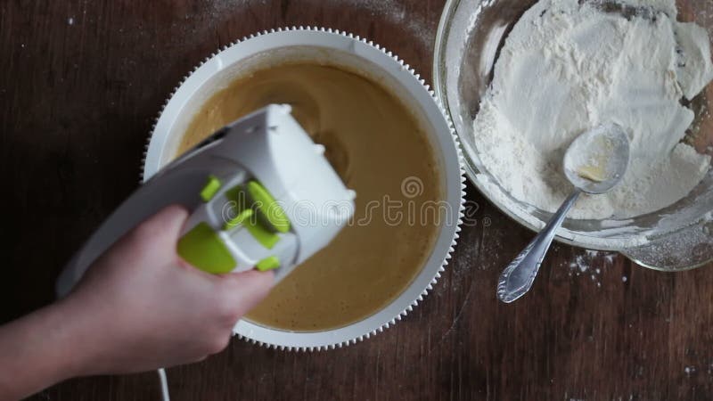 Mixing dough with electric mixer. Cooking at home.