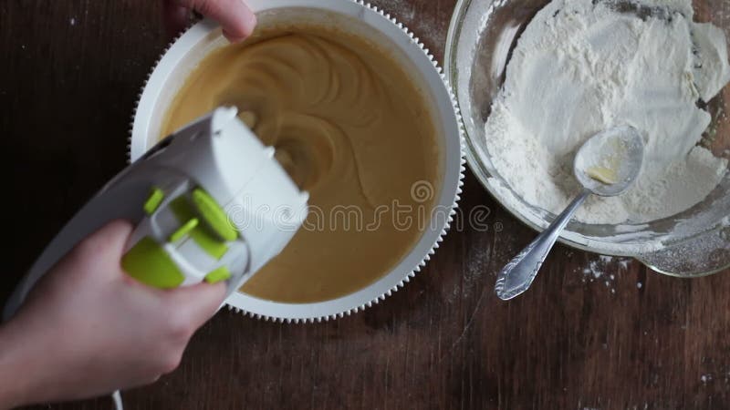 Mixing dough with electric mixer. Cooking at home.