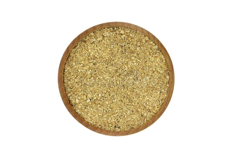 A mixture of crushed spices and herbs in a wooden bowl royalty free stock image