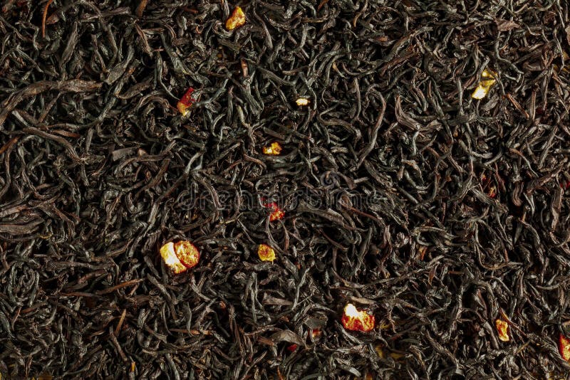 A Mixture of Dry Black Tea and Pieces of Dried Strawberries As a