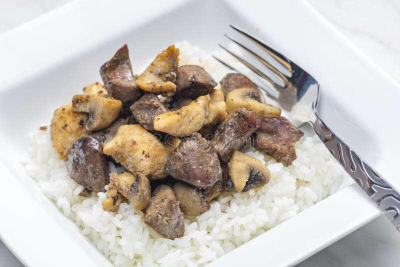 Mixture of Fried Livers, Poultry Meat and Champignons Served with Rice