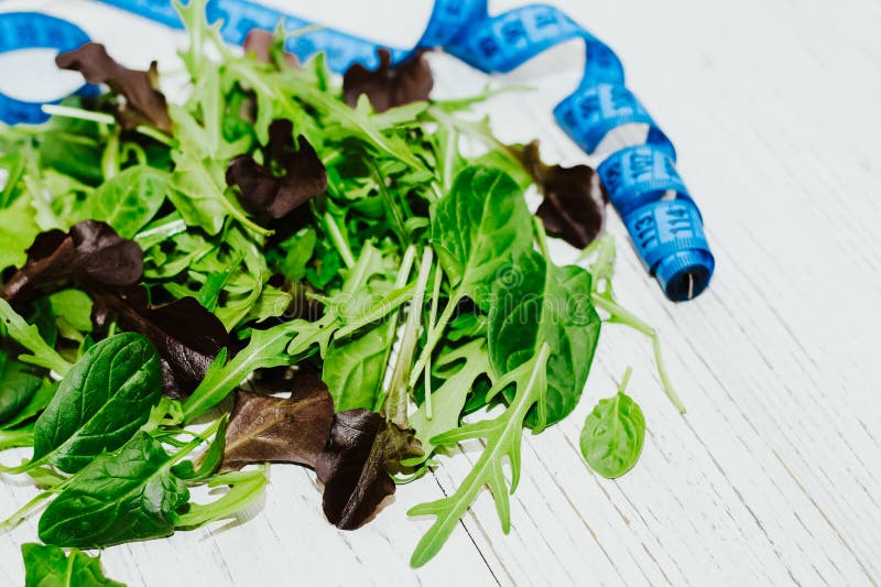 A Mixture of Lettuce Leaves Different Types with a Centimeter for