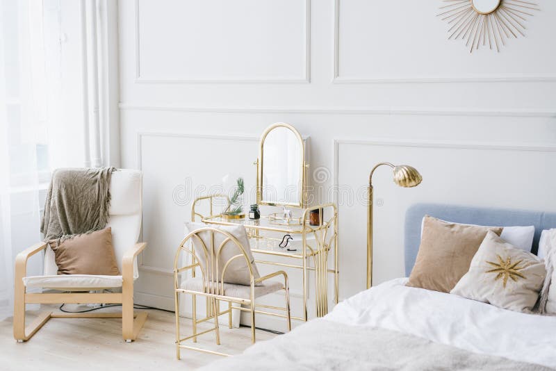 A soft light bedroom with a bed, chair and boudoir table by the window for a young girl in Scandinavian or neoclassical style. A soft light bedroom with a bed, chair and boudoir table by the window for a young girl in Scandinavian or neoclassical style.