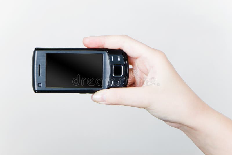 Mobiele telefoon in zijn hand stock afbeelding Mobiele telefoon in zijn hand stock afbeelding