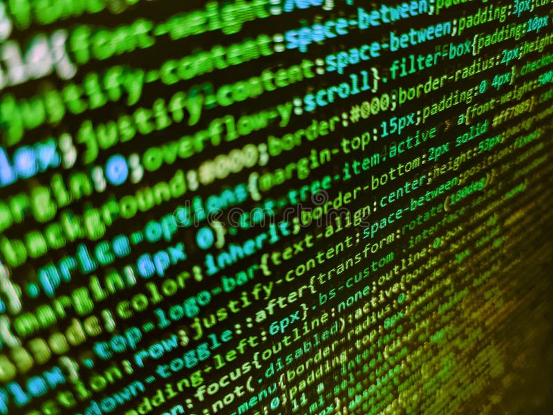 Mobile app developer. Shallow depth of field, selective focus effect. Lots of digits on the computer screen. Programmer working on stock photography