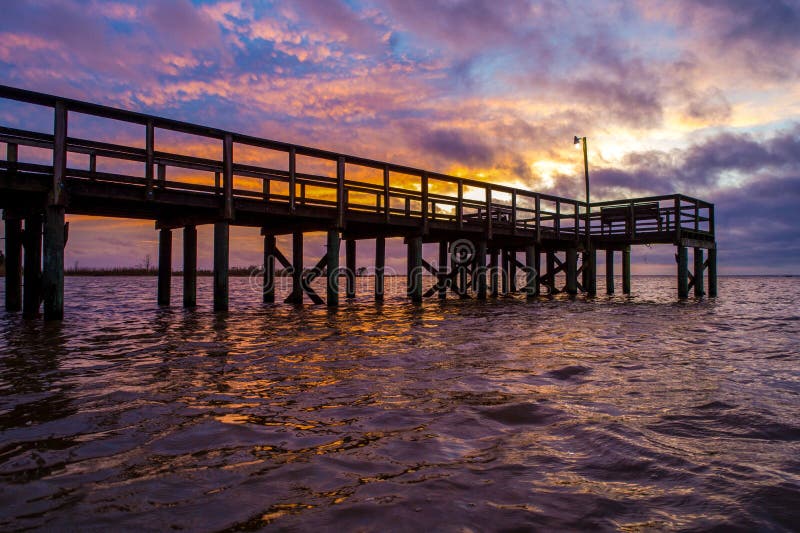 Mobile Bay at sunset stock image. Image of bridge, beach 254385243
