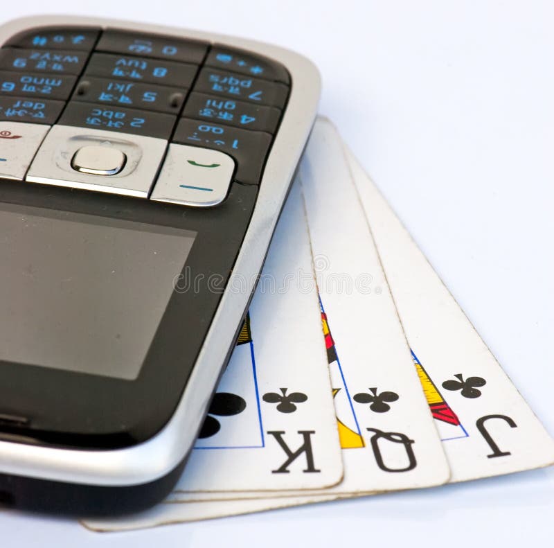 Mobile phone on 3 used playing cards