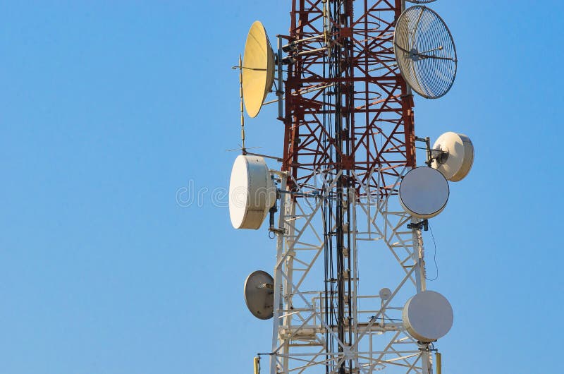 Mobile Phone Communication Antenna Tower With Satellite Dish On Blue