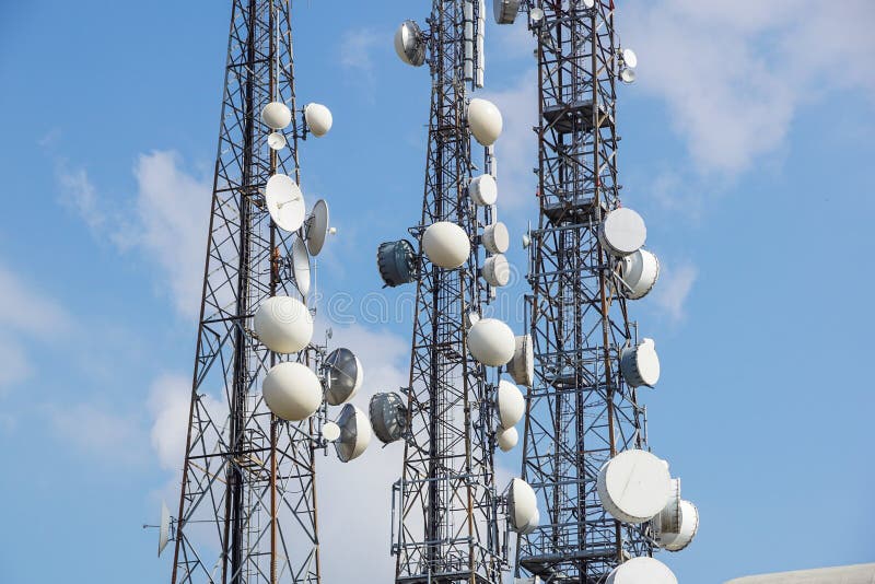 Mobile phone communication antenna tower with satellite dish on blue sky background, Telecommunication tower stock photography Mobile phone communication antenna tower with satellite dish on blue sky background, Telecommunication tower stock photography