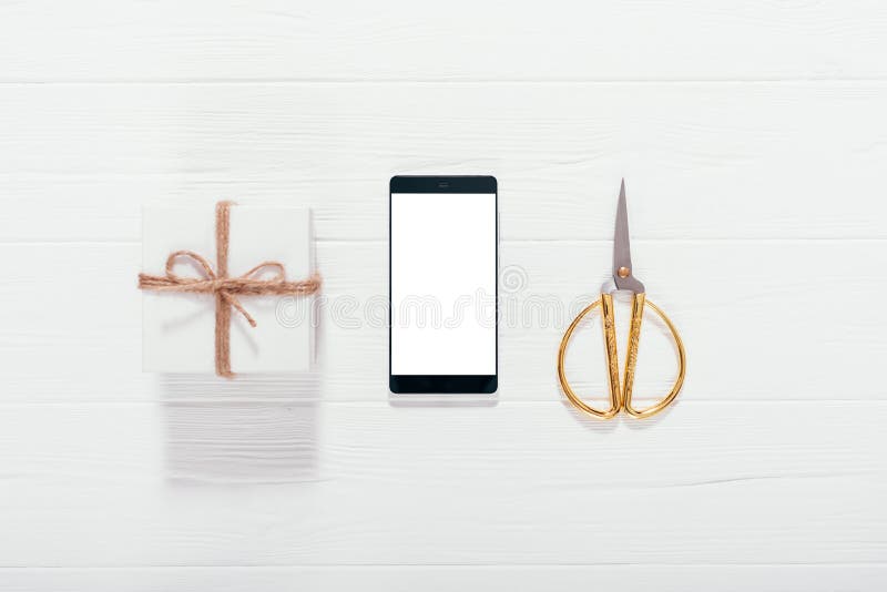 Mobile phone, gift box and gold scissors royalty free stock photos Mobile phone, gift box and gold scissors royalty free stock photos