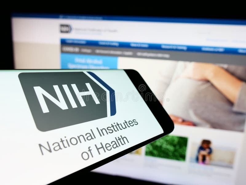 Mobile phone with logo of US agency National Institutes of Health (NIH) on screen in front of website. stock images Mobile phone with logo of US agency National Institutes of Health (NIH) on screen in front of website. stock images