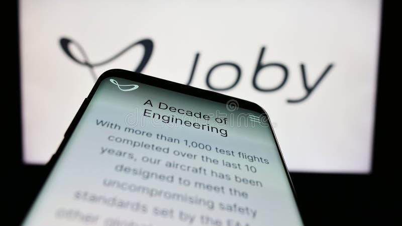 Stuttgart, Germany - 03-31-2023: Mobile phone with web page of American eVTOL company Joby Aviation on screen in front of business logo. Focus on top-left of phone display.