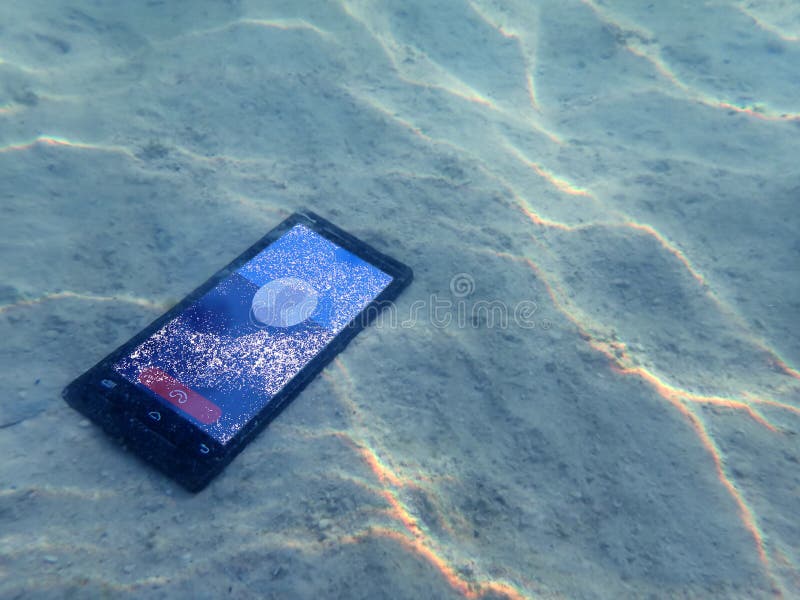 Mobile Phones on the Sand Under the Sea Water. Stock Image Image of