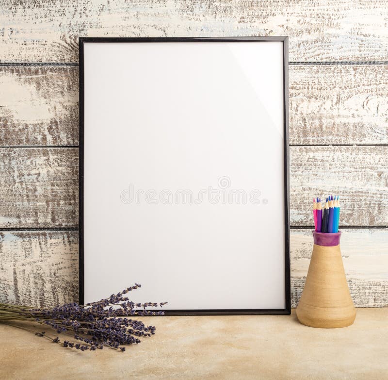 Mock up of an empty frame poster on a wall of wooden boards. stock photo Mock up of an empty frame poster on a wall of wooden boards. stock photo