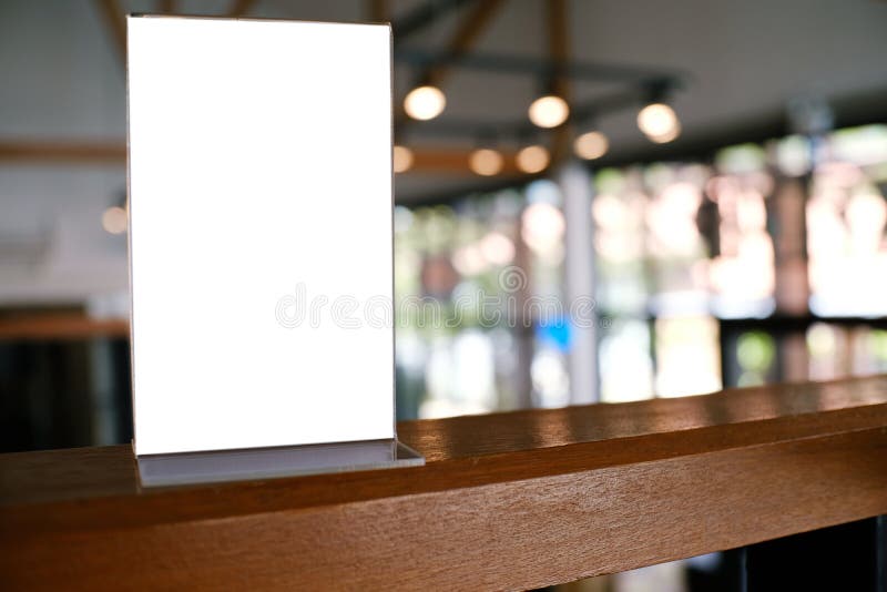 Mock up Menu frame standing on wood table in Bar restaurant cafe stock photo Mock up Menu frame standing on wood table in Bar restaurant cafe stock photo