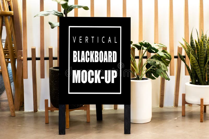 Mock up vertical advertising blackboard on floor at restaurant royalty free stock photography