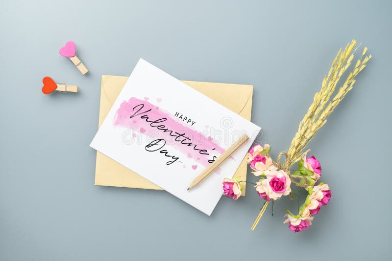 Mockup blank postcard and envelope on grey table background with craft rose flower. Mock up for elegant design. Flat lay top view stock image Mockup blank postcard and envelope on grey table background with craft rose flower. Mock up for elegant design. Flat lay top view stock image