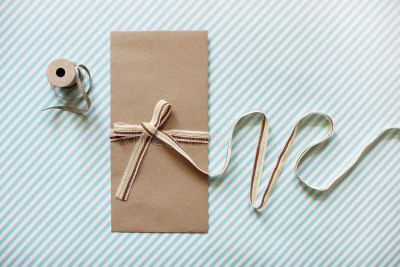 Mockup image of Blank Craft Envelope tied with Fabric Ribbon. Fl stock photography