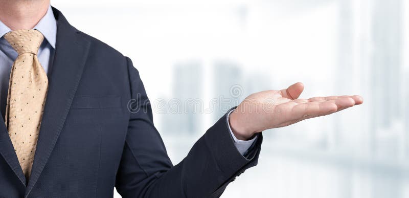 Mockup image. businessman holds palm with blank space for your text and design on blurred office background. Businessman hold open stock photos