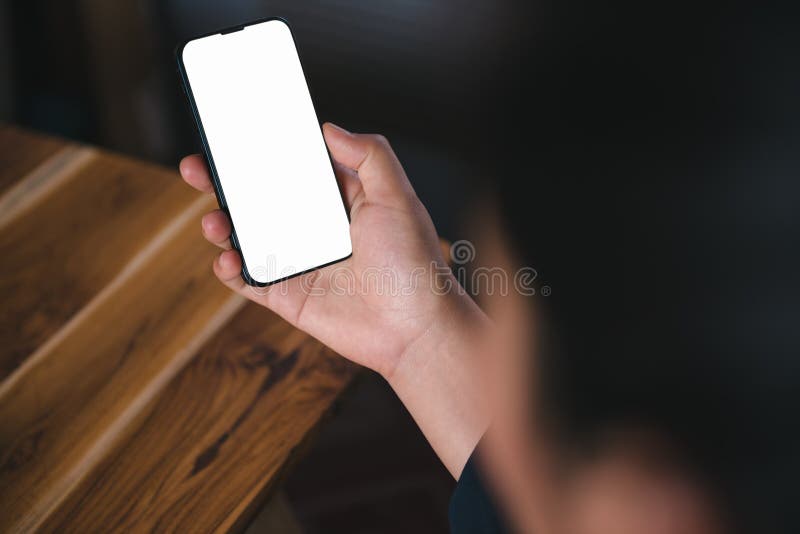 Mockup Image of Woman`s Hands is Using Smartphone With Empty White Screen for Coppy Space on Office Desk. Digital Mobile Phone stock image