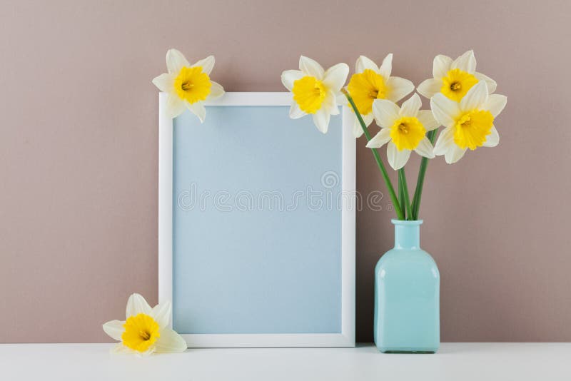 Mockup of picture frame decorated narcissus flowers in vase with clean space for text your blogging and greeting for mother day. royalty free stock photos Mockup of picture frame decorated narcissus flowers in vase with clean space for text your blogging and greeting for mother day. royalty free stock photos