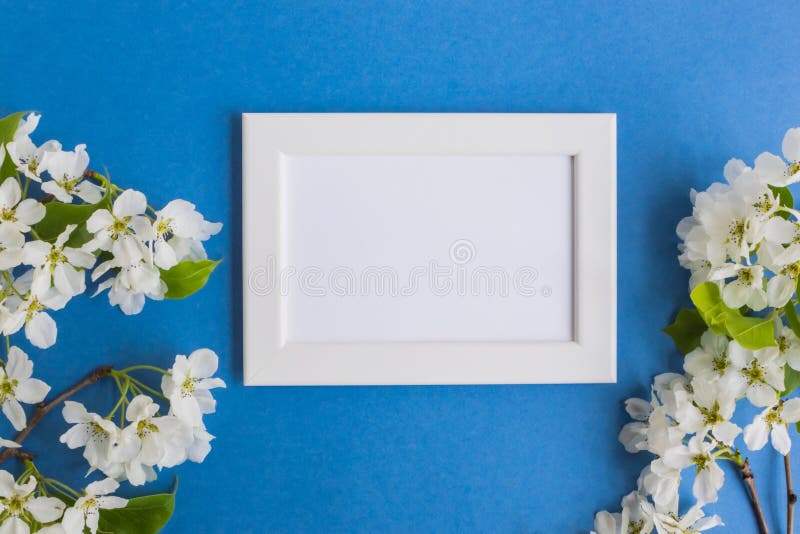 Download Mockup With A White Frame And White Spring Flowers Stock ...